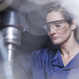 Woman working drill press